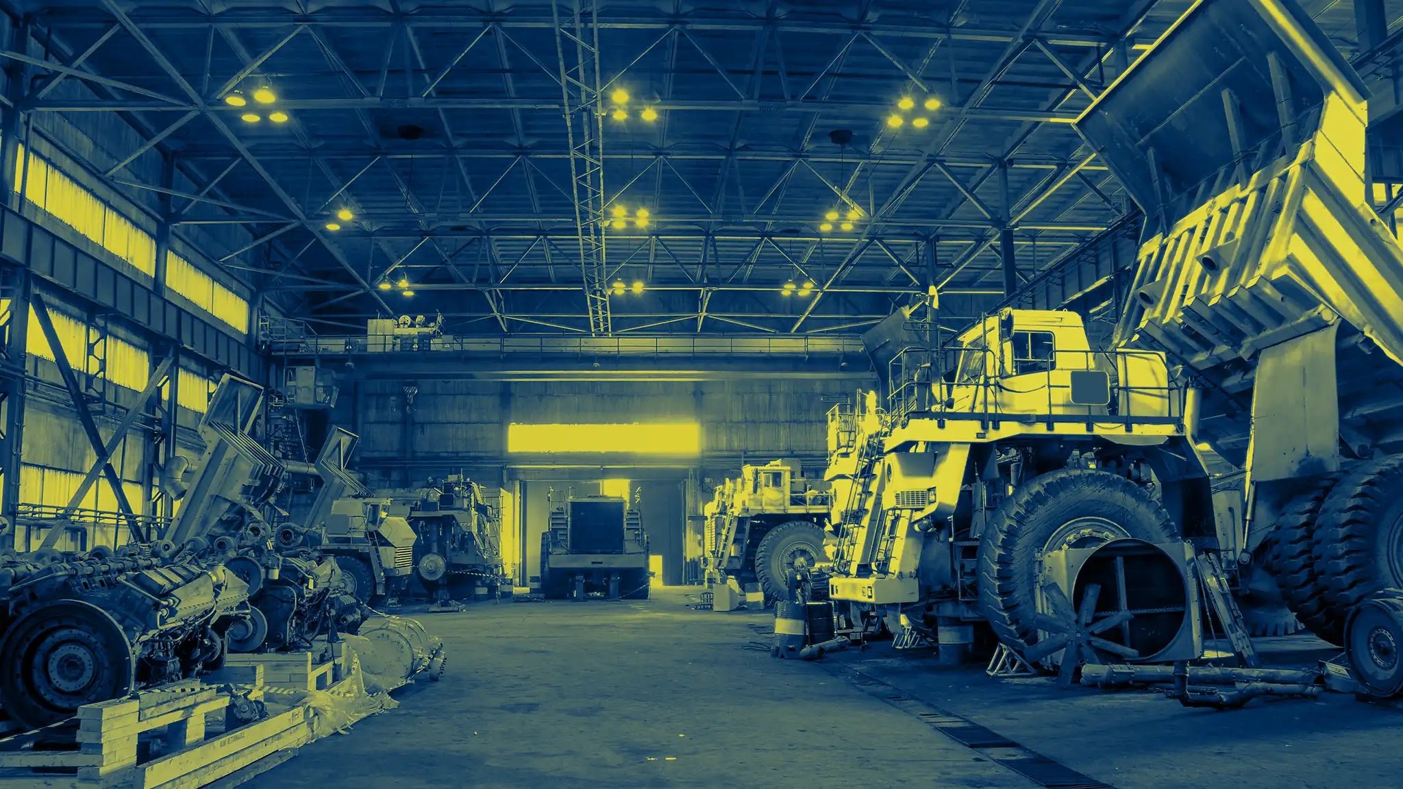 Mining site workshop with heavy haul trucks maintained using Durst industrial battery chargers