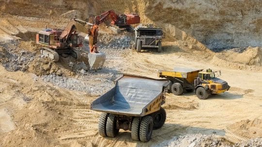 Dump trucks and excavators at mining site Visit Durst Industries at MINExpo 2024 in Vegas